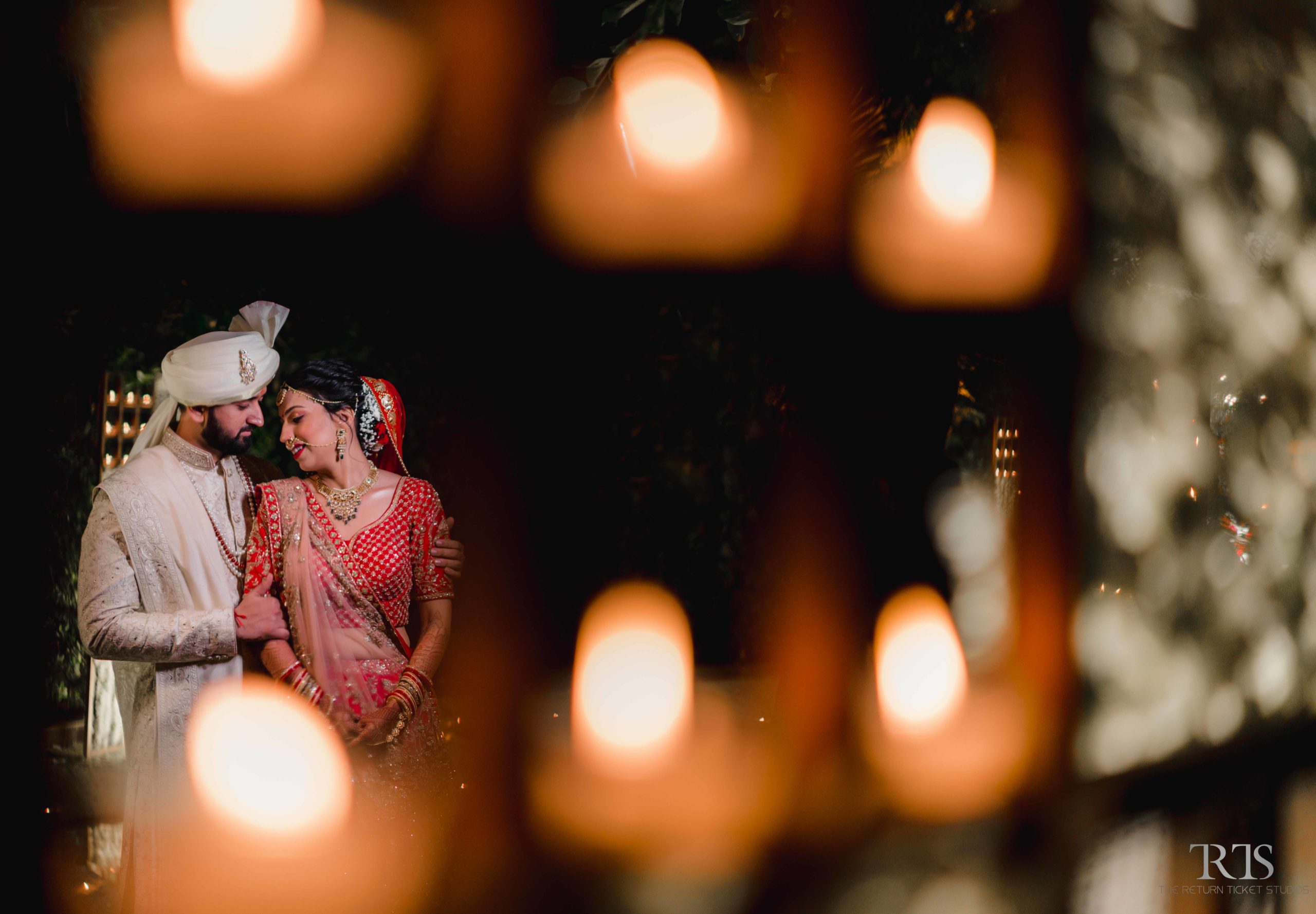 beautiful couple photo in front of diya Beautiful candid photography of pre wedding and wedding by The Return Ticket Studios 