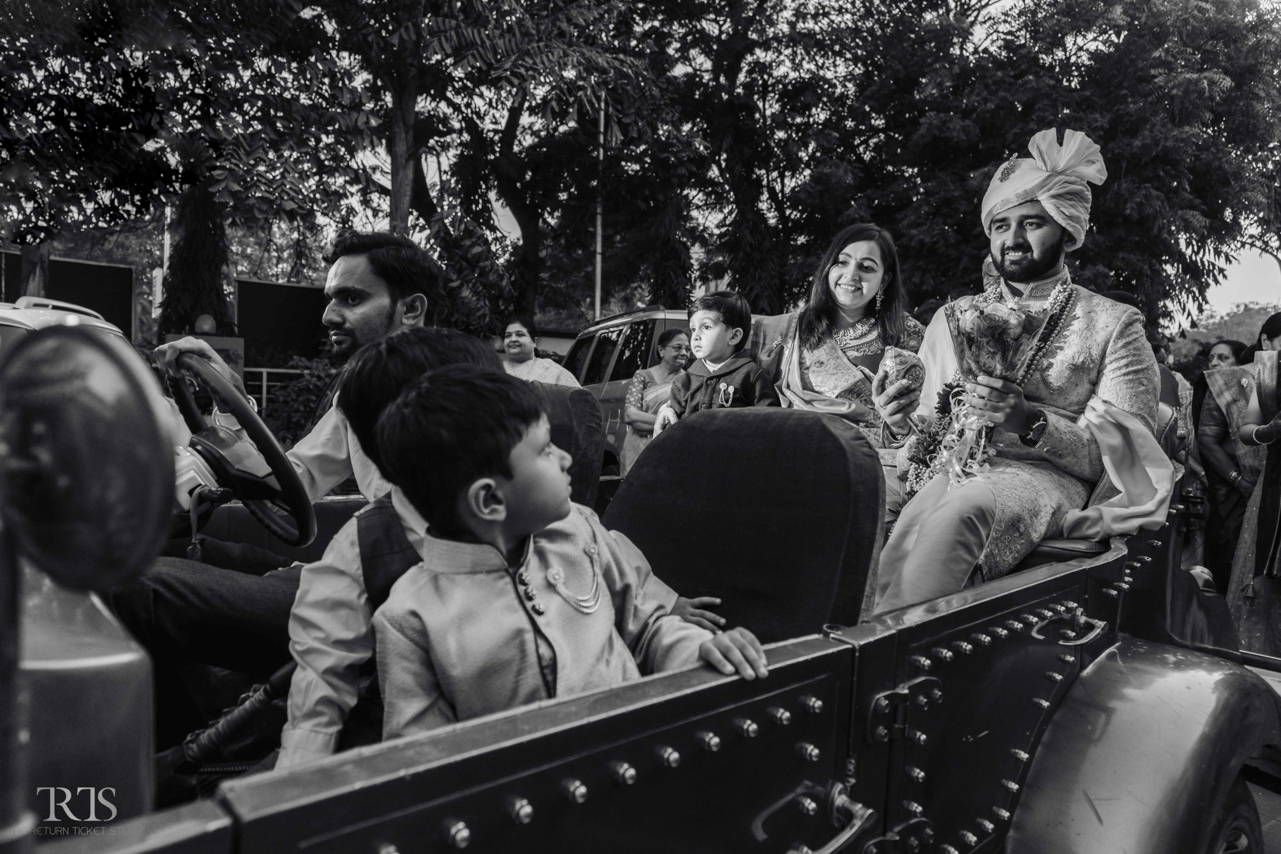 black and white photo in vintage car Beautiful candid photography of pre wedding and wedding by The Return Ticket Studios 