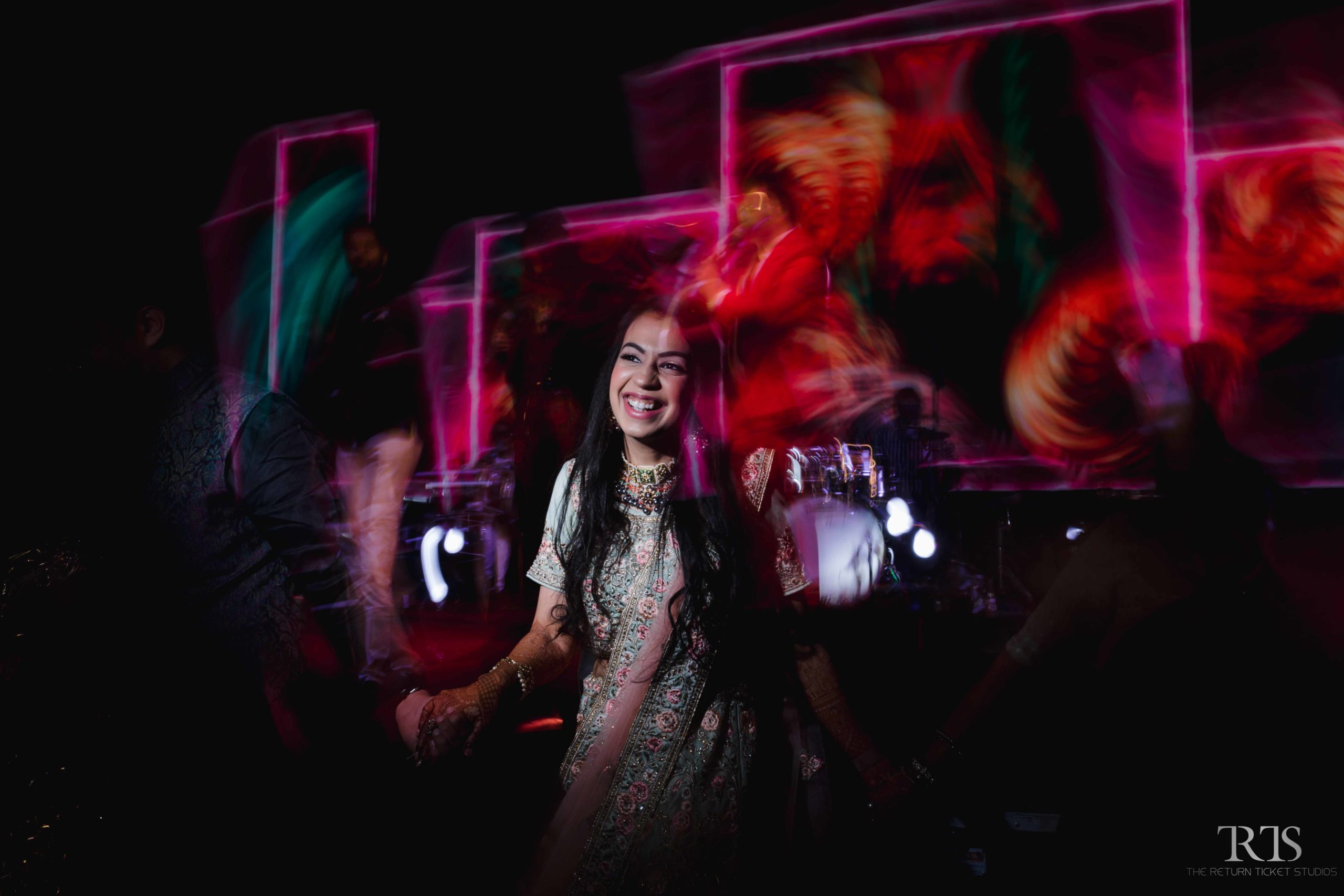 bride dancing in the sangeet ceremony Beautiful candid photography of pre wedding and wedding by The Return Ticket Studios 