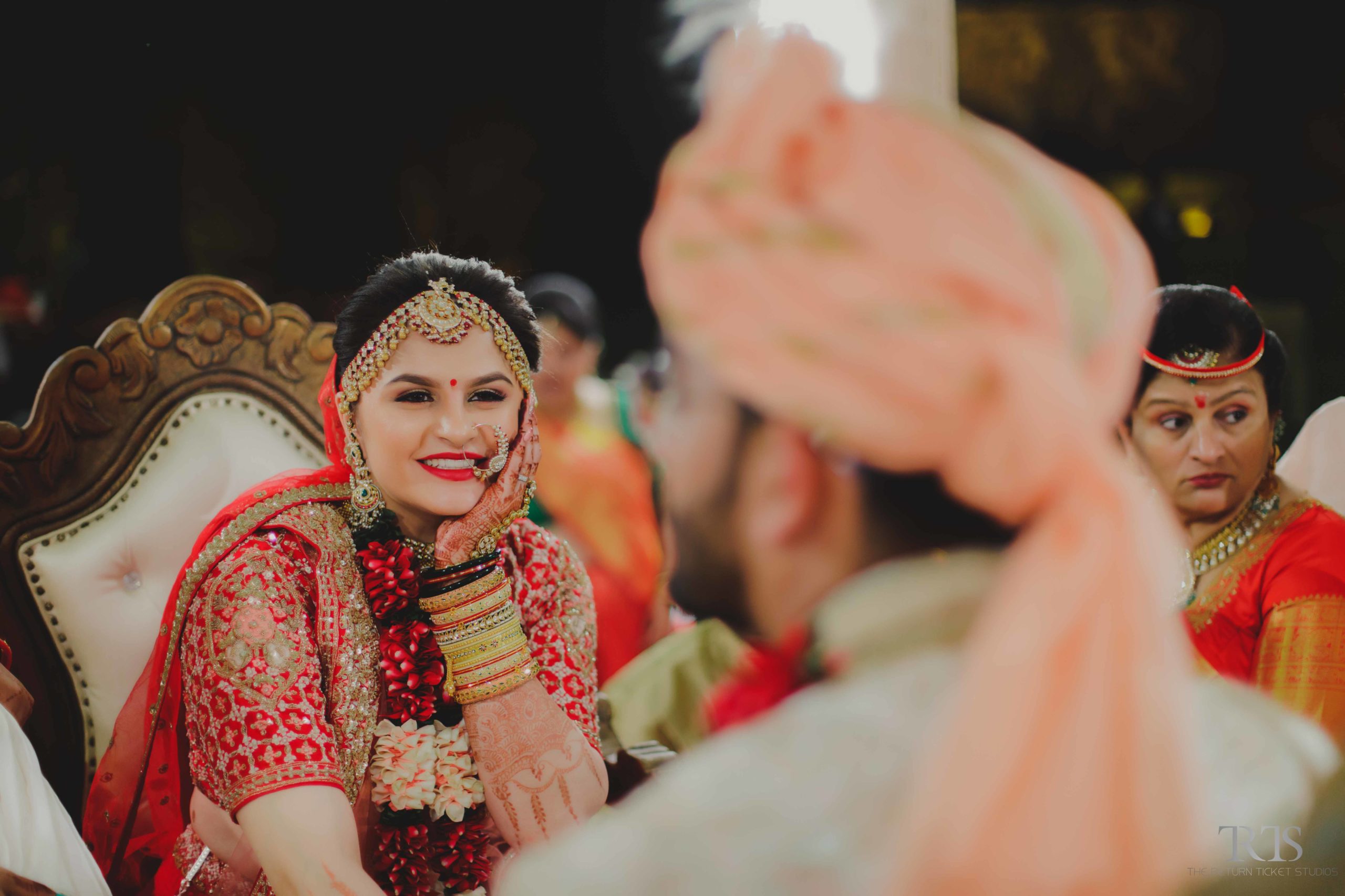 bride smiling at the groom in the ahmedabad Beautiful candid photography of pre wedding and wedding by The Return Ticket Studios 