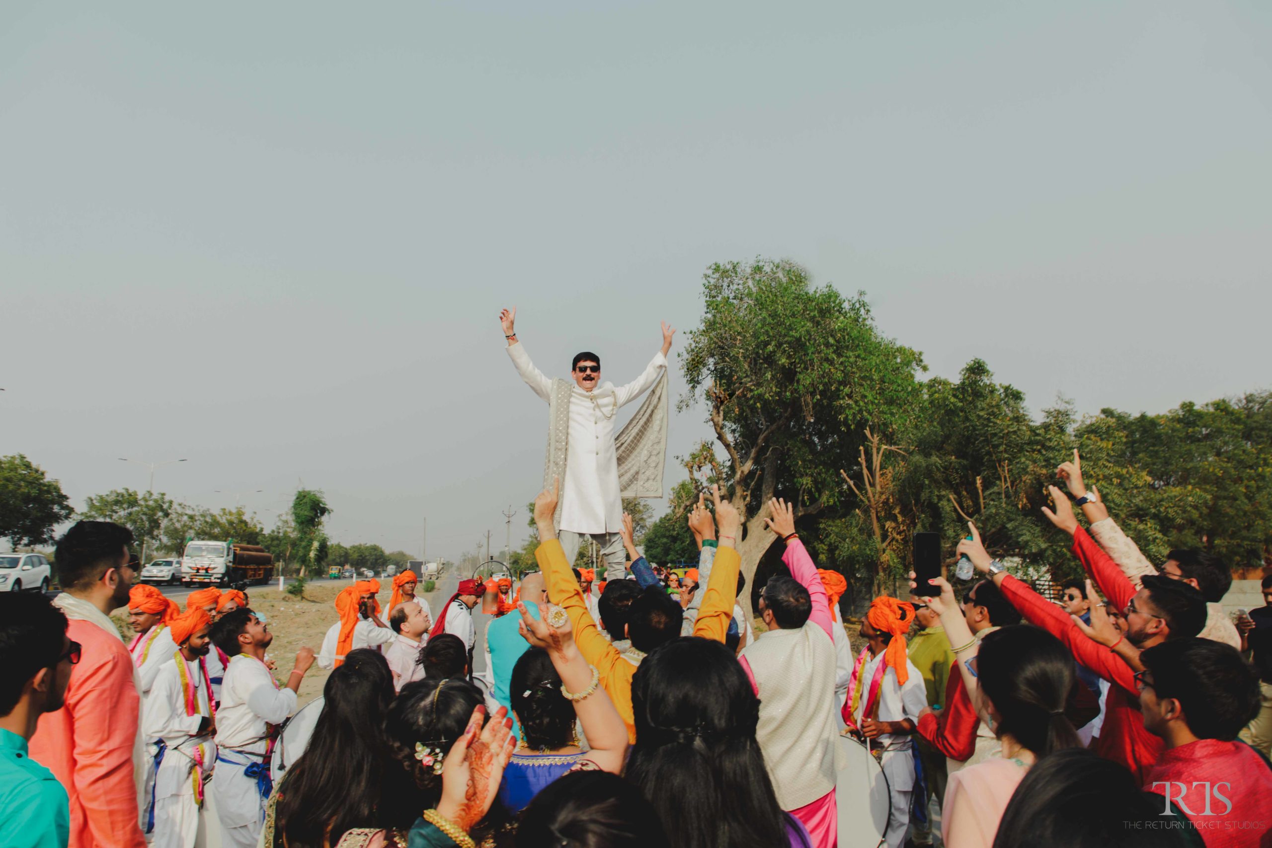 groom's father dancing in the baarat Beautiful candid photography of pre wedding and wedding by The Return Ticket Studios 