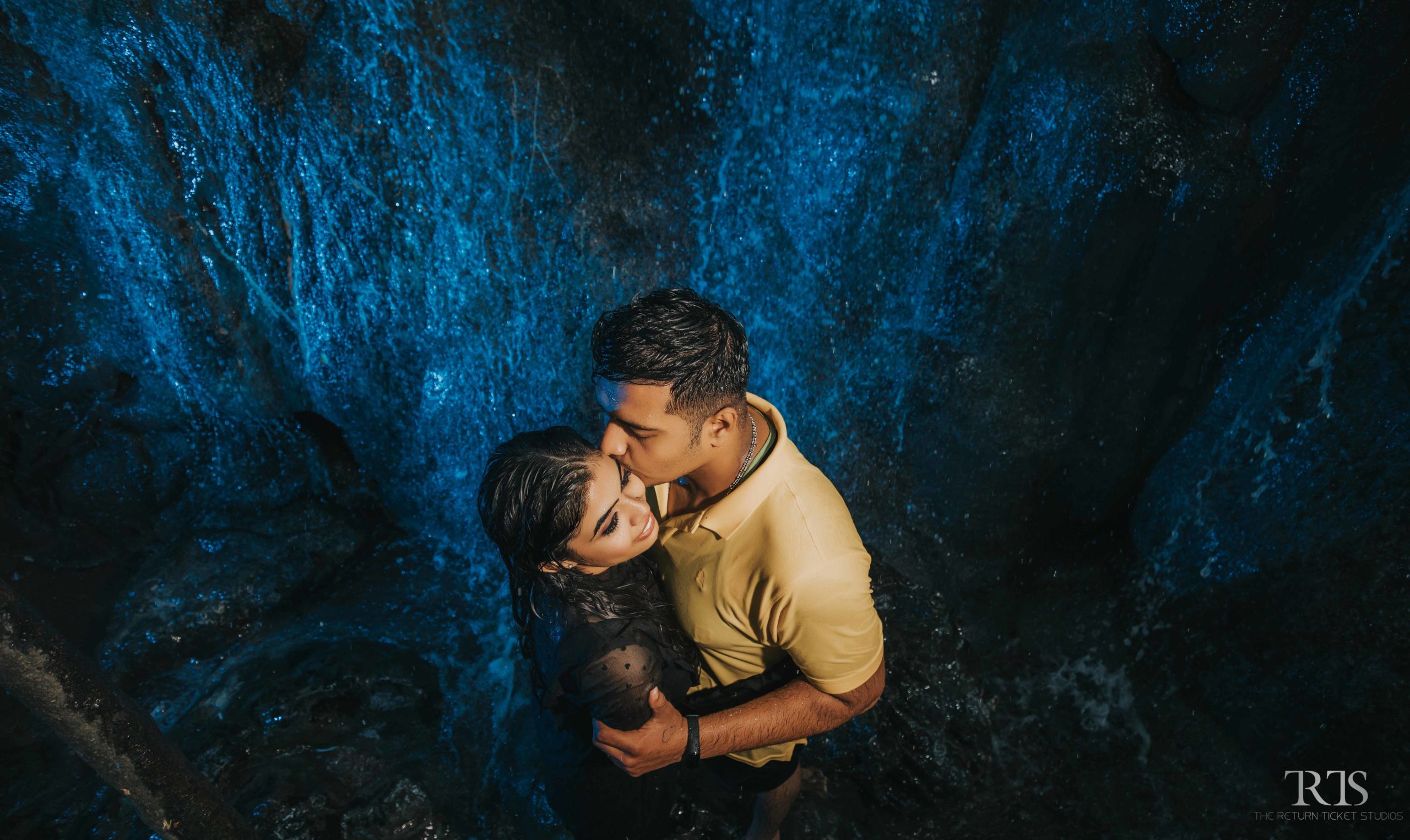 couple kissing near water fall Beautiful candid photography of pre wedding and wedding by The Return Ticket Studios 