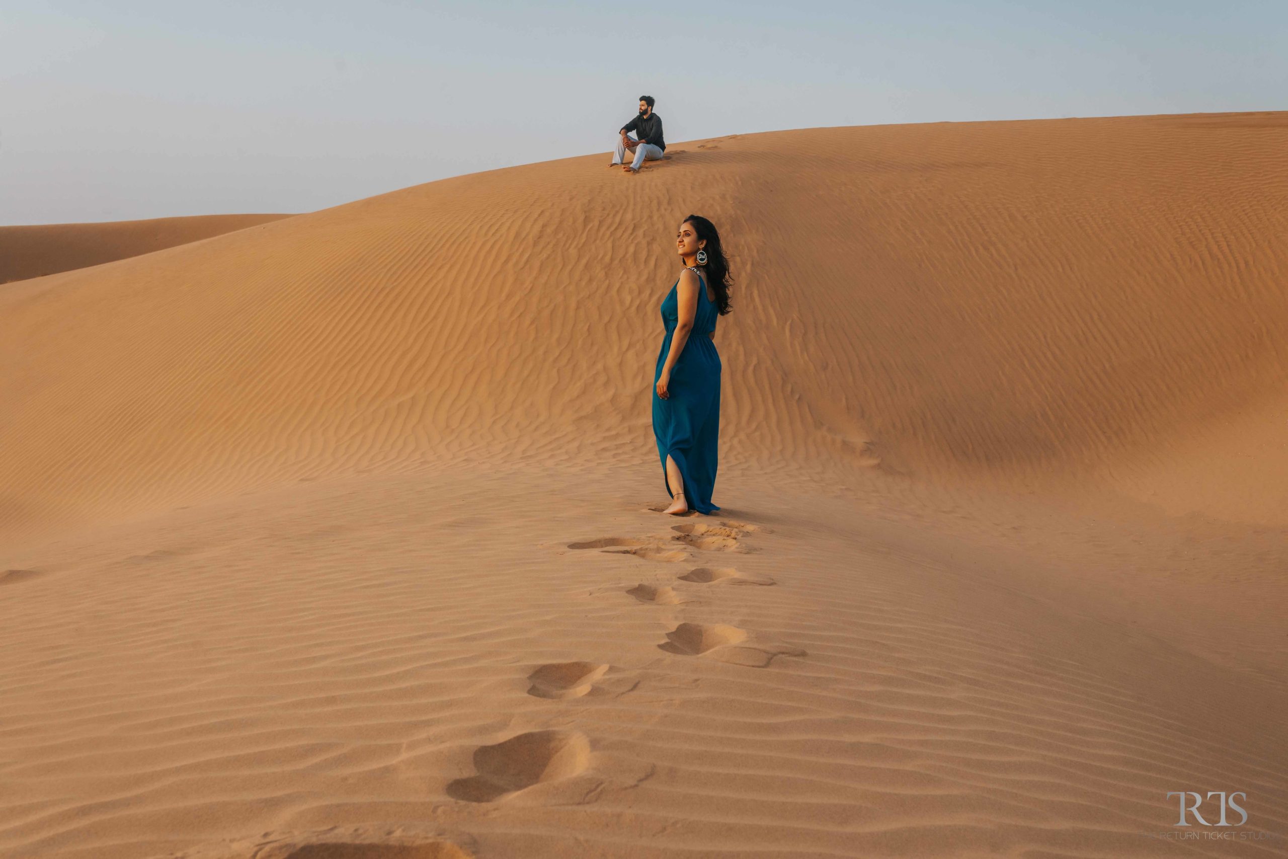 couple in the desert with blue dress Beautiful candid photography of pre wedding and wedding by The Return Ticket Studios 