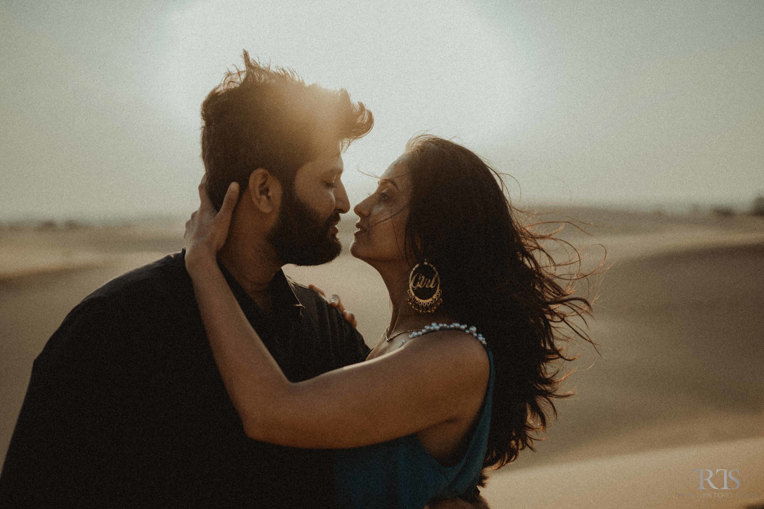 couple kissing in the desert Beautiful candid photography of pre wedding and wedding by The Return Ticket Studios 